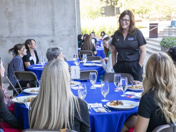 Image of Lisa Romero speaking with YWOI/WOI honorees