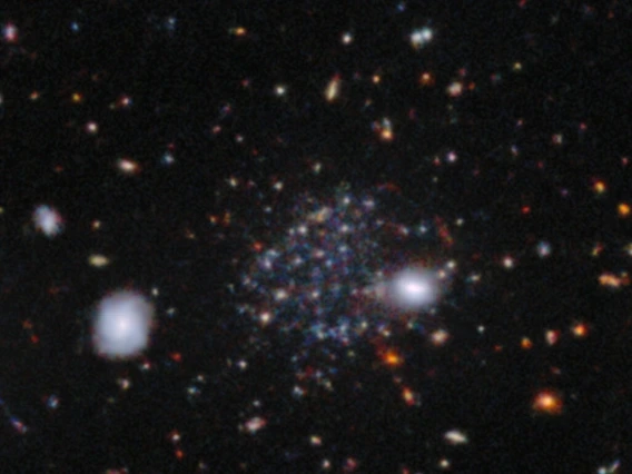 Sculptor A, one of three newly discovered dwarf galaxies - and unrelated to the well-known Sculptor spiral galaxy - is visible here as a faint accumulation of stars beyond several bright stars in the foreground. 