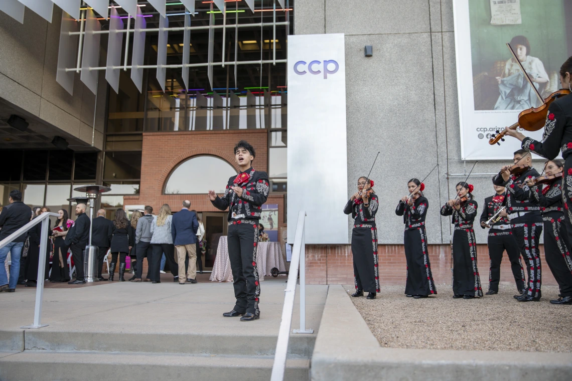 A mariachi band plays to a crowd in front of the Center for Creative Photography.