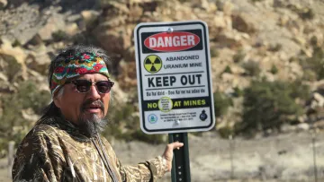 Earl Tulley shows the Indige-FEWSS students around a former uranium mine.