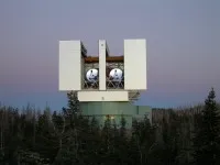 The two primary mirrors  are visible in this photo taken of the Large Binocular Telescope at dusk